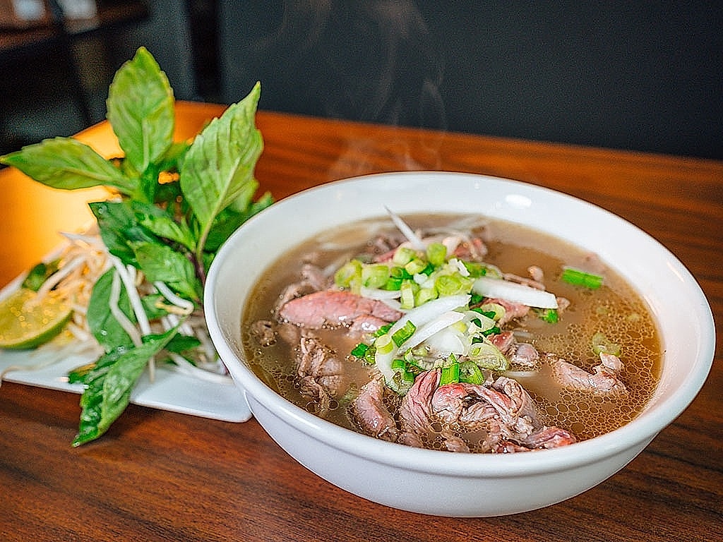 Steaming hot bowl of authentic Hanoi beef pho with scallions
